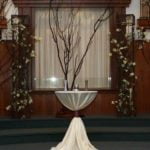 Round cocktail table with shantung swirl tablecloth and decorative branches, used in a Sand Ceremony setting for events in Little Rock, AR.